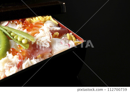 Chirashi sushi with various ingredients taken on a black background 112700739