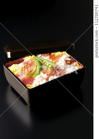 Chirashi sushi with various ingredients taken on a black background 112700741