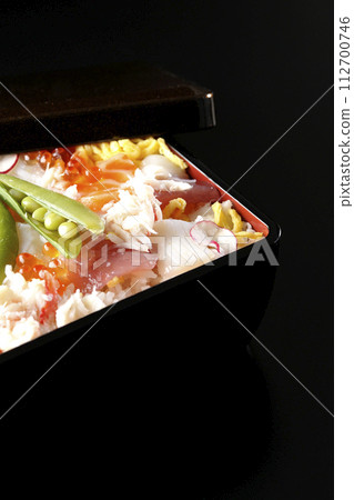 Chirashi sushi with various ingredients taken on a black background Chirashi sushi with various ingredients taken on a black background 112700746
