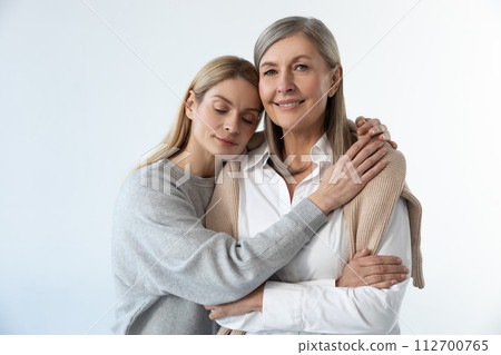 Two women standing close and looking peaceful and relaxed Two women standing close and looking peaceful and relaxed 112700765