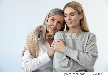 Two women standing close and looking peaceful and relaxed 112700766