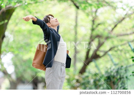 A woman stretching in fresh greenery A woman stretching in fresh greenery 112700856