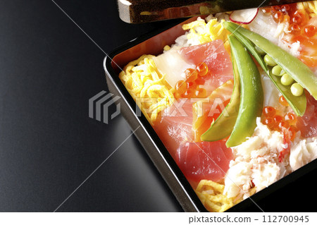 Chirashi sushi with various ingredients taken on a black background 112700945