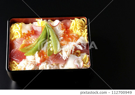 Chirashi sushi with various ingredients taken on a black background Chirashi sushi with various ingredients taken on a black background 112700949