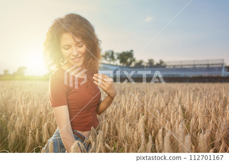 Beautiful woman in the wheat field 112701167