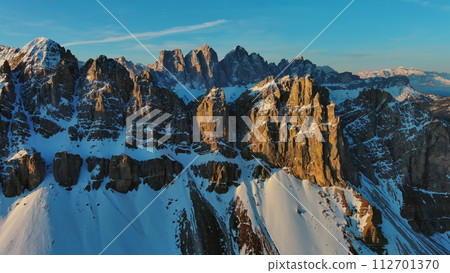 Rocky snow mountains at sunrise aerial 112701370