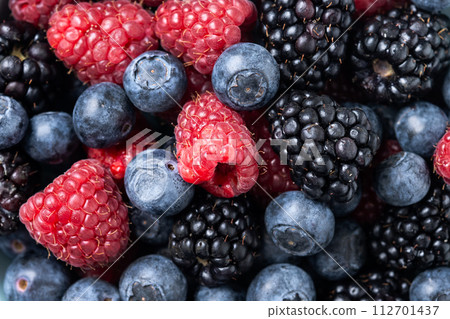 Fresh assortment berries in bowl background Fresh assortment berries in bowl background 112701437
