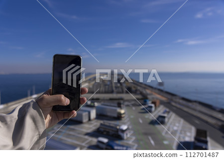 People taking pictures of Umihotaru PA and Tokyo Bay Aqua Line with smartphones People taking pictures of Umihotaru PA and Tokyo Bay Aqua Line with smartphones 112701487