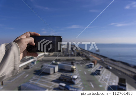 People taking pictures of Umihotaru PA and Tokyo Bay Aqua Line with smartphones People taking pictures of Umihotaru PA and Tokyo Bay Aqua Line with smartphones 112701493