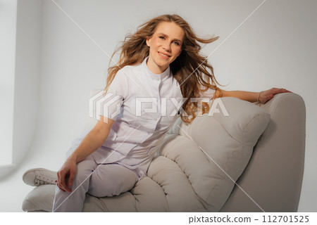 Portrait of confident female doctor in suit, smiling, looking at camera Portrait of confident female doctor in suit, smiling, looking at camera 112701525