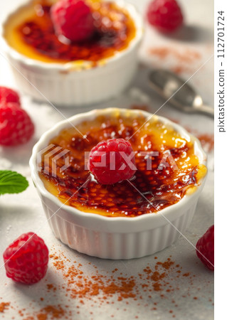 Delicious creme brulee in a ceramic plate on a white background 112701724