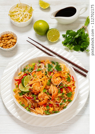 pad thai with shrimps, peanuts, eggs, bean sprouts pad thai with shrimps, peanuts, eggs, bean sprouts 112702175