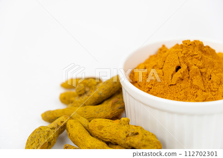 Turmeric powder, spices and dried root on white background, copy space for text. Turmeric powder, spices and dried root on white background, copy space for text. 112702301