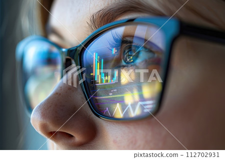 A close-up of a person's face, with a reflection of graphs and numbers in their glasses. Generative AI 112702931