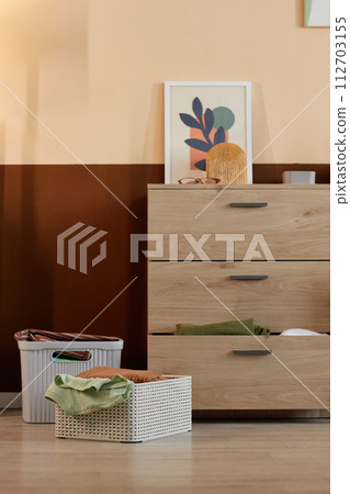 Minimal background image of clean clothes in storage containers in home interior 112703155