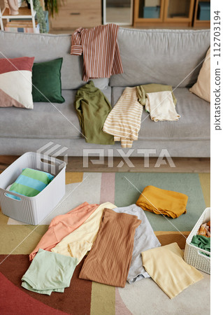 Background image of clean clothes sorted in stacks and storage boxes in home interior 112703194