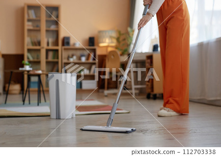 Cropped shot of unrecognizable woman mopping floors at home and enjoying Spring cleaning copy space Cropped shot of unrecognizable woman mopping floors at home and enjoying Spring cleaning copy space 112703338