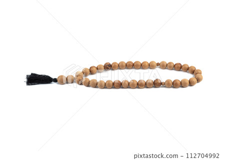 Wooden rosary for meditation or religious practice on a white background. Wooden rosary for meditation or religious practice on a white background. 112704992