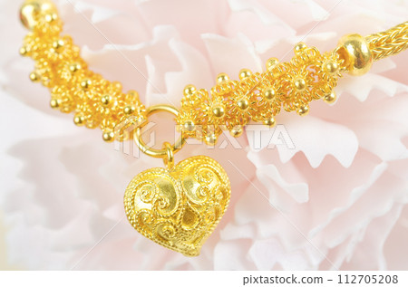The Gold Bracelet on beautiful pink flower. The Gold Bracelet on beautiful pink flower. 112705208