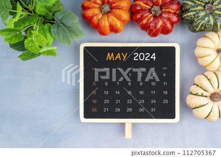 View from above to simple May 2024 calendar decorated with pumpkin. 112705367