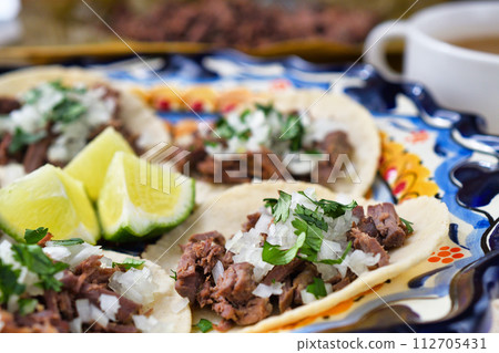 Mexican barbacoa beef tacos and beef barbacoa and barbacoa consommé Mexican barbacoa beef tacos and beef barbacoa and barbacoa consommé 112705431