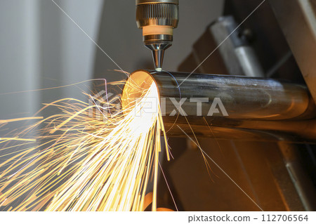 Close up scene the fiber laser cutting machine cut the stainless steel tube and sparkling light. Close up scene the fiber laser cutting machine cut the stainless steel tube and sparkling light. 112706564