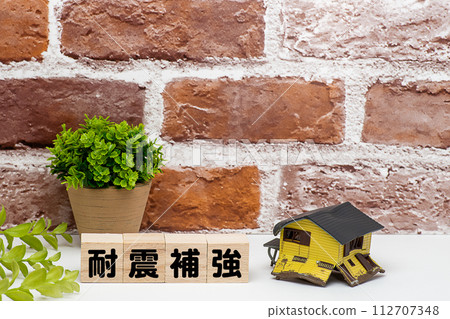 A house that collapsed due to an earthquake and text material for earthquake reinforcement 112707348