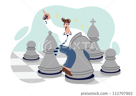Business man plays chess sitting astride knight chess piece, demonstrating strategic thinking 112707802