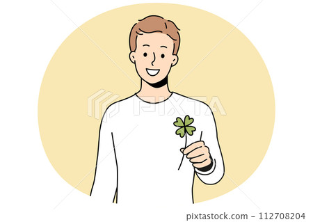 Smiling man holding clover with four leaves 112708204