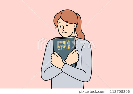 Believing woman embraces bible and feels enlightened after reading religious christian book 112708206