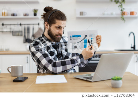 Qualified data analyst demonstrating information about business growth. 112708304