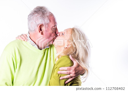 Affectionate Senior Couple Sharing a Kiss Affectionate Senior Couple Sharing a Kiss 112708402