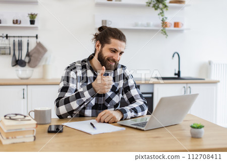 Positive business manager explaining new details of project using internet app. Positive business manager explaining new details of project using internet app. 112708411