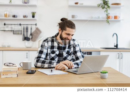 Caucasian professional talking to client over video call while staying at home. 112708414