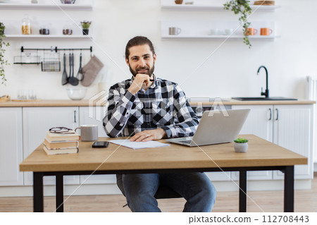 Business person posing with pen, documents and portable computer. Business person posing with pen, documents and portable computer. 112708443