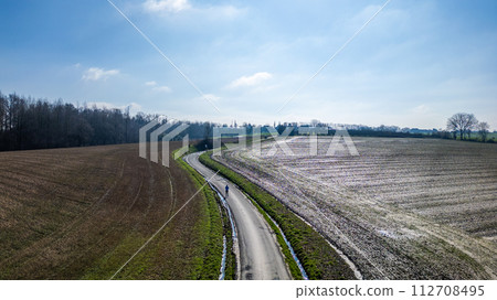 Aerial Perspective of Curved Road Amidst Fields 112708495