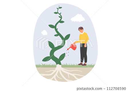 Man waters fantastic tree, enjoying rapid growth of plant thanks to high-quality fertilizer 112708590