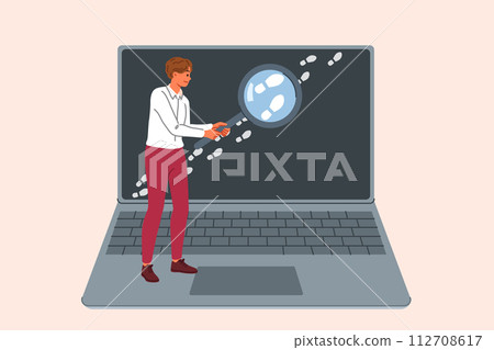 Man is looking for traces on internet, working OSINT specialist and holding loupe near laptop 112708617