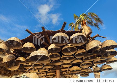 wicker lanterns against a background of blue sky 112710393