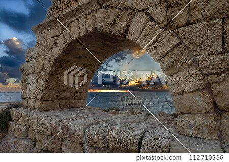 Aqueduct built by the Romans against the sky at sunset in Caesarea Israel 112710586