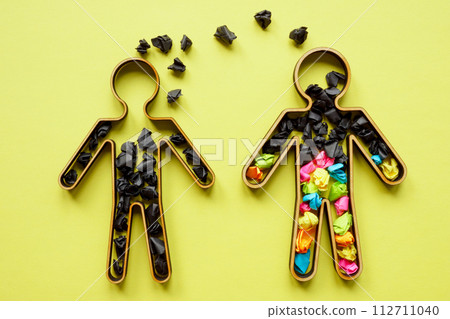 Concept of unhealthy communication, negative emotions and toxicity. Two figures with black and colored paper balls. Concept of unhealthy communication, negative emotions and toxicity. Two figures with black and colored paper balls. 112711040