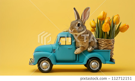 fluffy bunny in on a blue truck is carrying bouquet of yellow tulips, yellow background, Easter greeting card 112712151