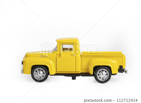 yellow iron toy car the truck isolated on a white background yellow iron toy car the truck isolated on a white background 112712914