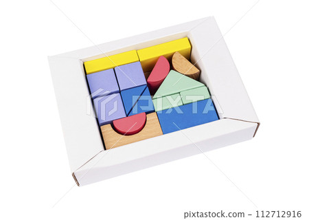 Coloured wooden figures in box on white background. Childrens building blocks. Geometric shapes. The concept of logical thinking. 112712916