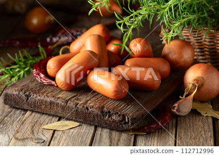 Sausages with rosemary, onion, garlic, red pepper, and bay leaves. Sausages with rosemary, onion, garlic, red pepper, and bay leaves. 112712996
