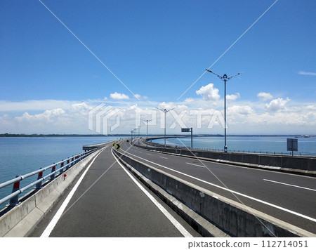 Riding along the part of the toll road designated for motorcycles across the water 112714051