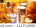 AI-generated content. Premium skincare essentials elegantly displayed amongst bright sunflowers, reflecting a luxury beauty experience. Generative Ai. 112714880