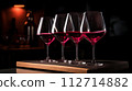 AI-generated content. Elegant Wine Glasses Lined Up with Pink Hue Generative Ai. 112714882