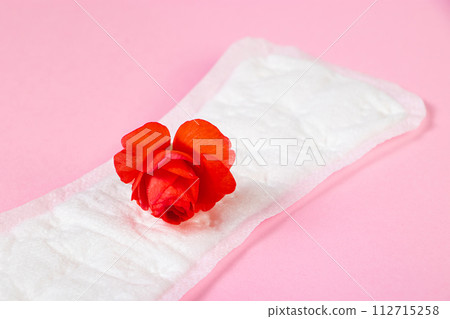 Sanitary pad and red flower on pink background. Menstruation concept. 112715258