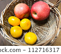 Oranges and apples in a basket 112716317